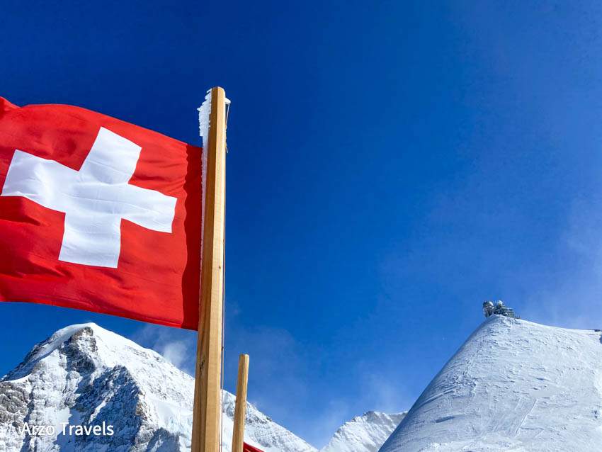 View of observatory from Jungfraujoch plateau with Swiss flag
