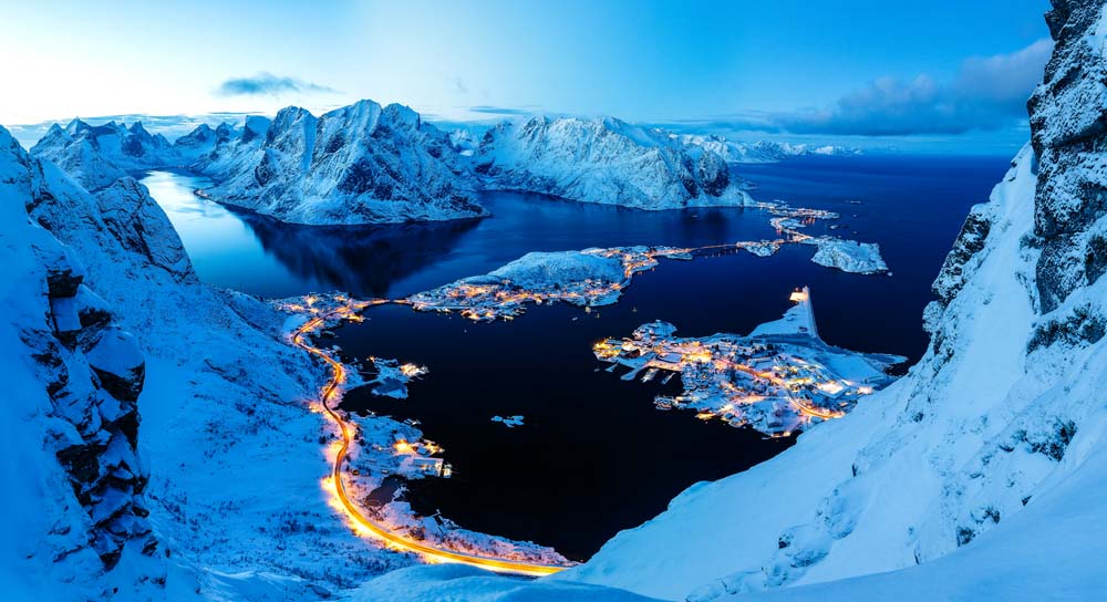 Breathtaking panorama of night surrounded by snowy peaks, Reinebringen Lofoten, Norway