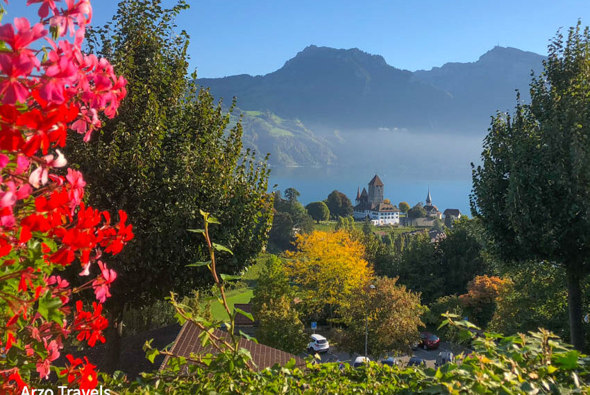 Spiez Castle with the lake, alps in background on hiking
