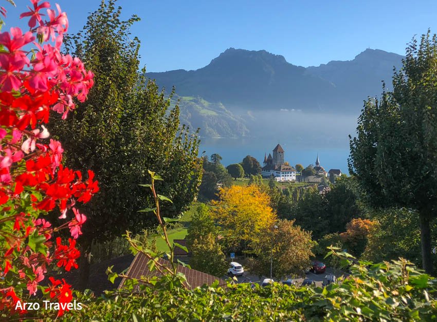 Spiez Castle with the lake, alps in background on hiking
